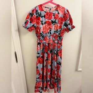 Short-sleeve ruffled flower dress. Inch longer than knee length